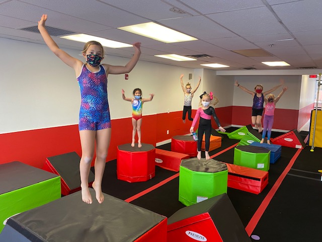 a group of kids jumping on a trampoline