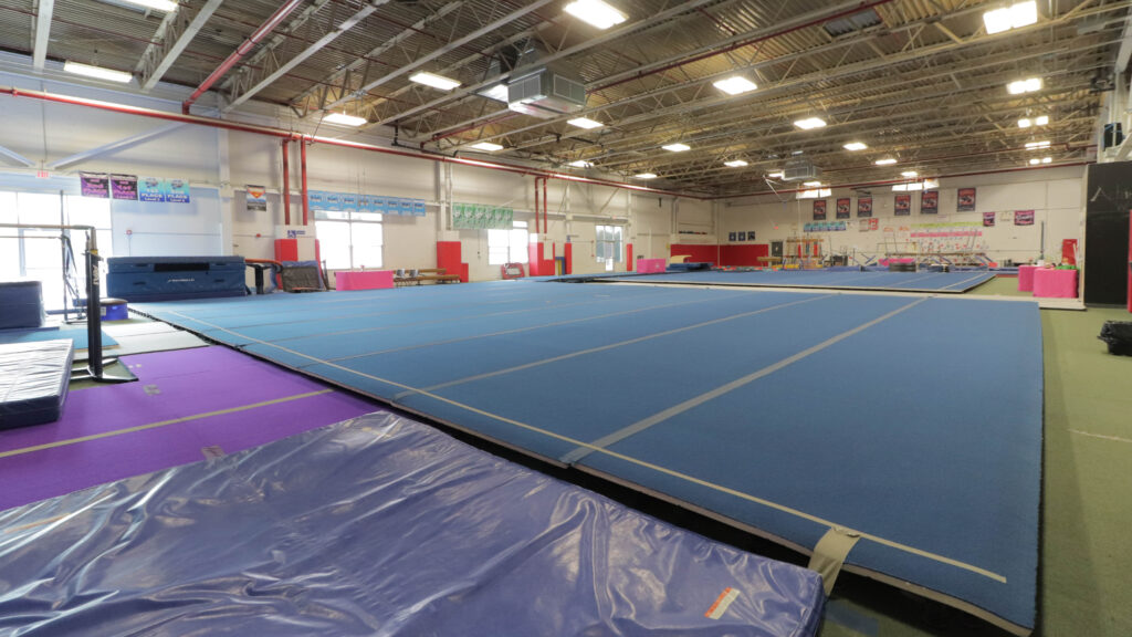 a large blue mat in a gym